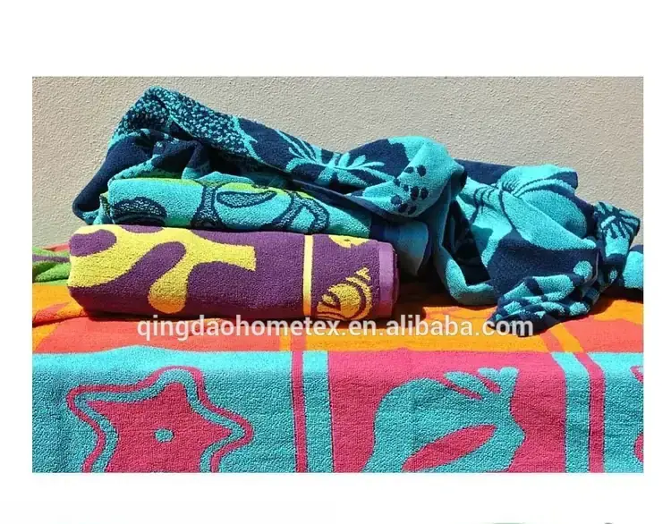 Stack of colorful printed beach towels in teal, purple, and orange patterns