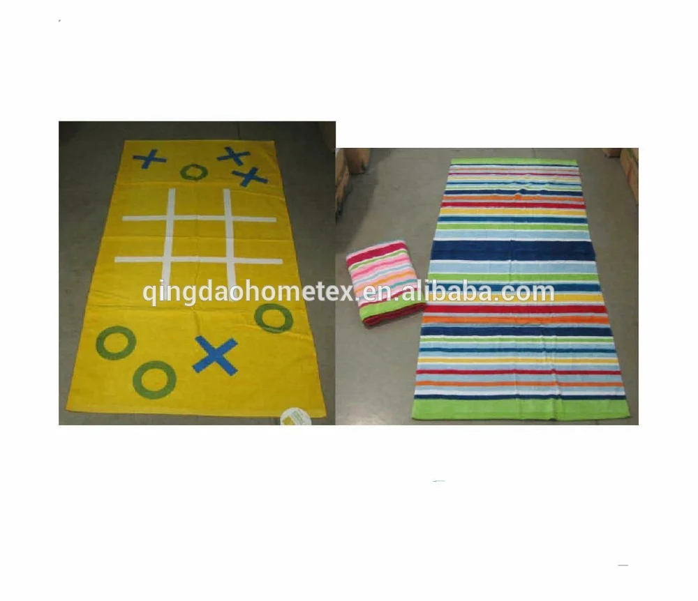 Two flat-woven towels: a yellow tic-tac-toe game towel and a multicolor striped towel on a concrete floor