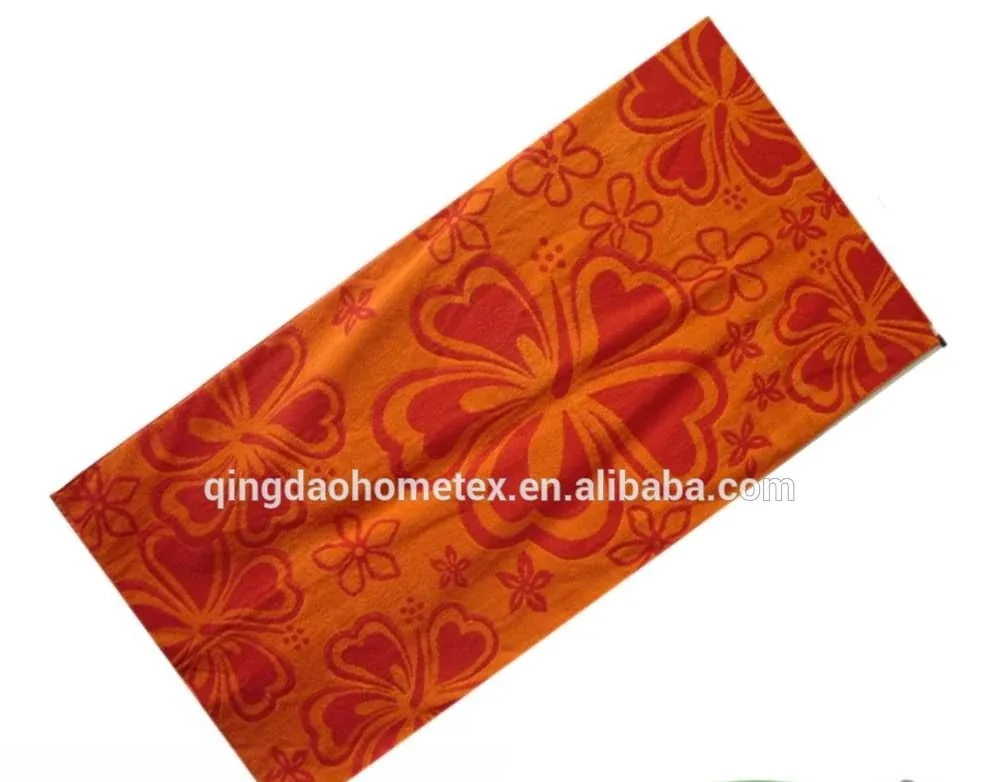 Orange and red floral print beach towel shown diagonally on white background with BSCI and Oeko-Tex logos