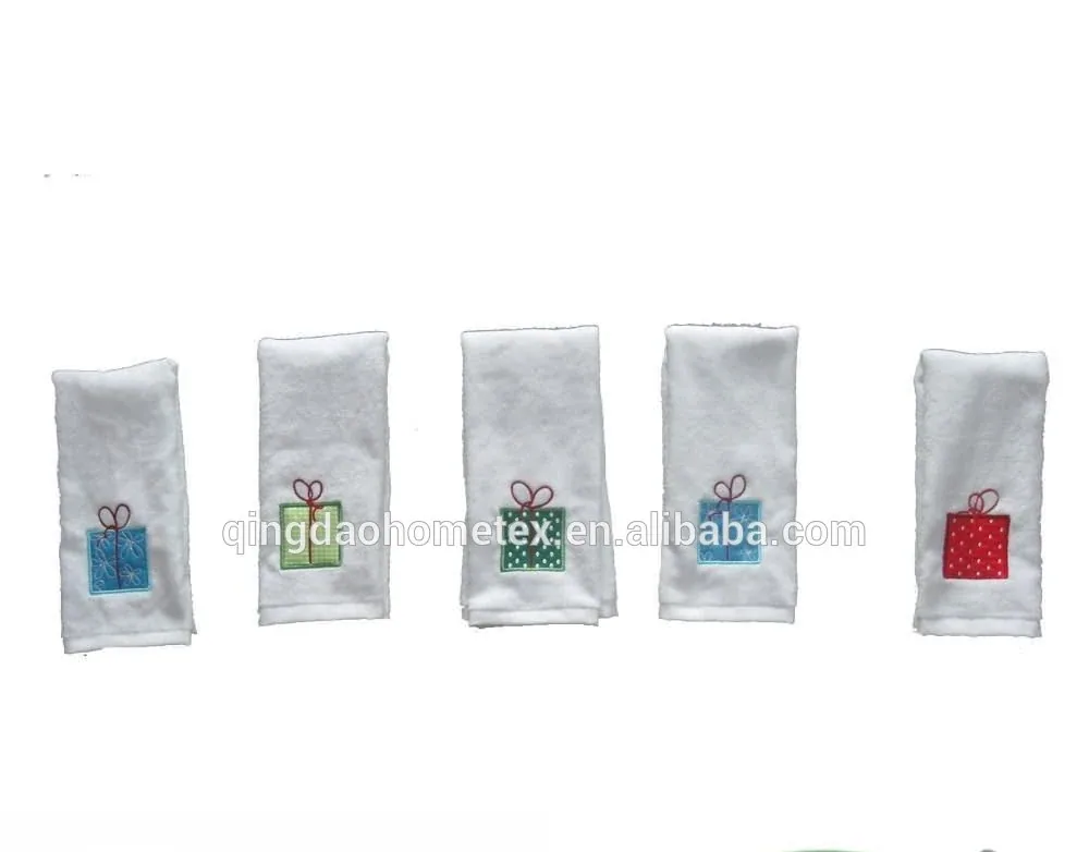 Five white towels with embroidered gift-box designs in different colors, hanging in a row on white background
