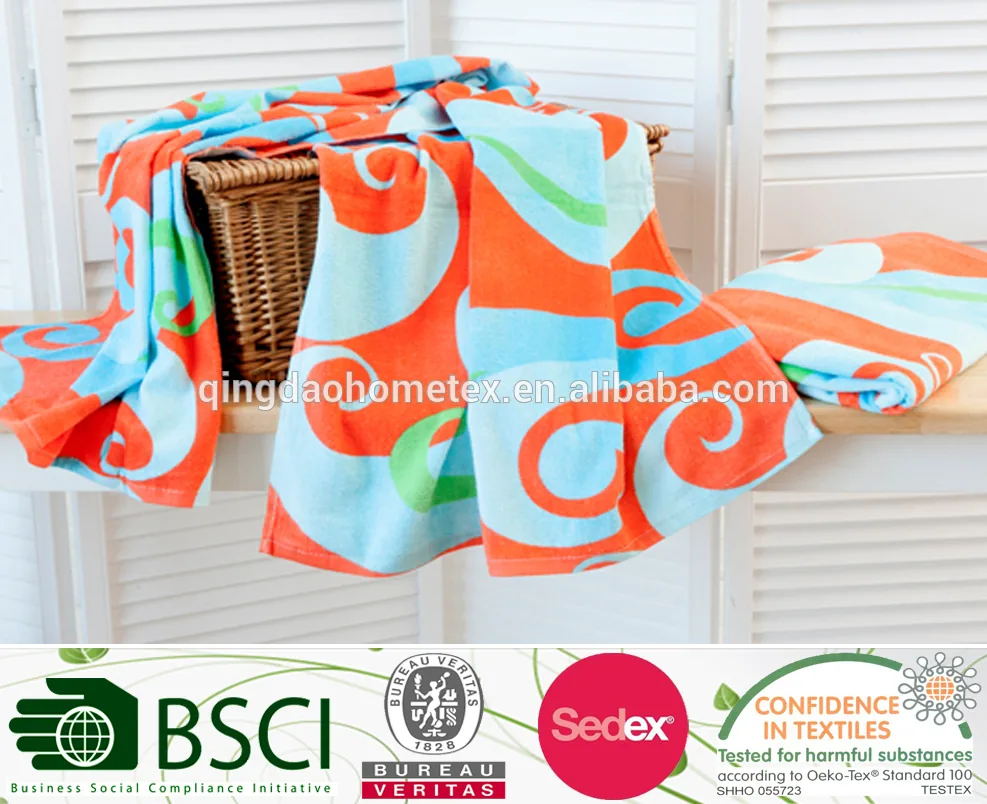 Colorful orange, blue and green printed towels draped over a wicker basket and white shutters