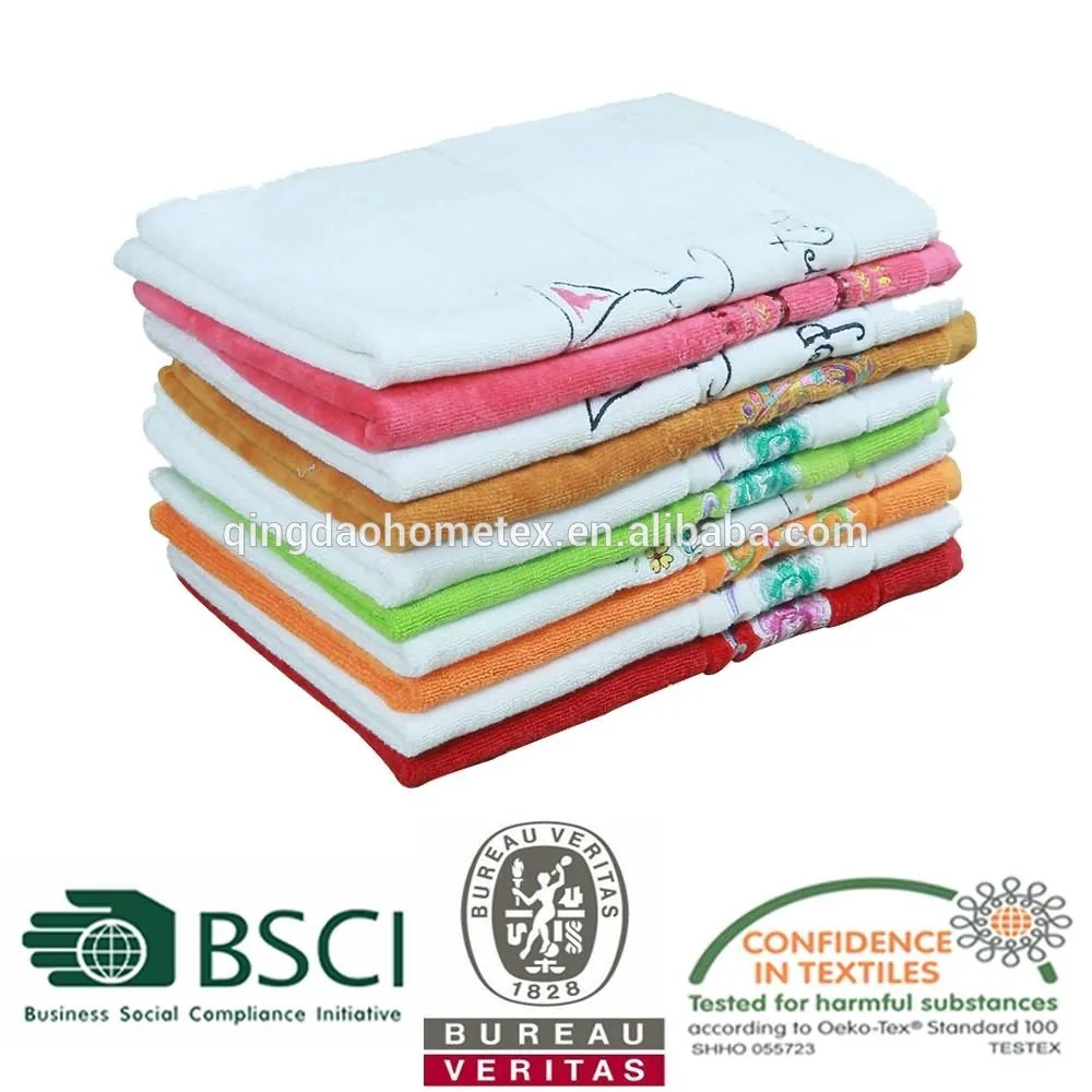 Stack of folded colorful embroidered towels on white background with certification logos and watermark text below