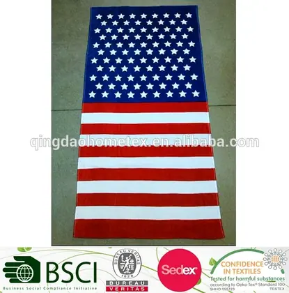 American flag pattern beach towel with white stars on blue field and red-and-white stripes, laid flat on a tiled floor