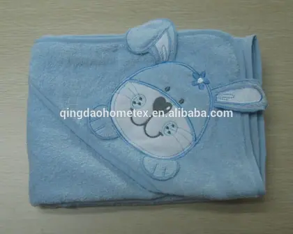 Light blue hooded baby towel with embroidered rabbit appliqué, folded on a plain surface