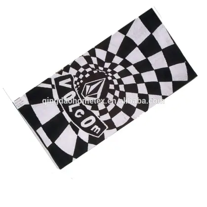 Black and white warped checkerboard towel with printed VOLCOM stone logo, tilted on white background