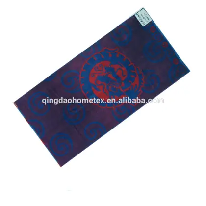 Purple printed towel with red dragon motif and blue swirl pattern, angled diagonally on white background
