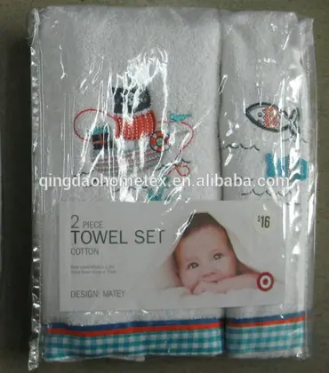 Packaged two-piece white cotton towel set with nautical embroidery and printed retail label