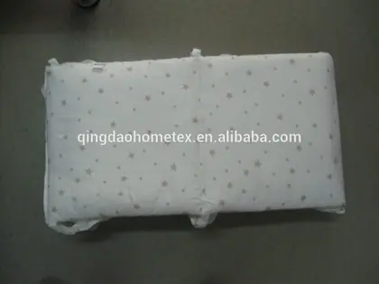 White quilted fabric pad with star print lying flat on a gray floor, overlaid with Alibaba URL watermark text