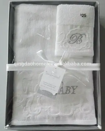 White embroidered baby towel set with ribbon and tag inside a gift box