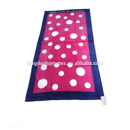 Pink and navy blue towel with large white polka dots.