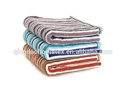 Stack of four folded striped towels in grey, teal, blue and red on a white background