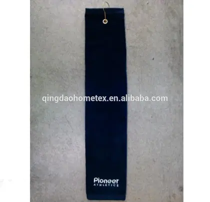 Navy blue sports towel with metal grommet and hook, embroidered brand text at bottom, photographed on a concrete floor