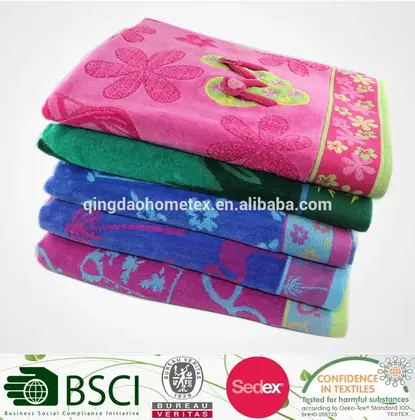 Stacked pink, green, blue, and purple folded towels with floral jacquard patterns.