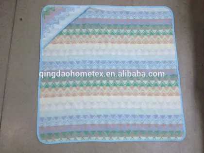 Folded blanket with pastel zigzag stripes lying on
