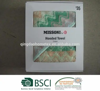 Packaging box for a hooded towel with windows showing green and tan zig-zag patterned fabric.
