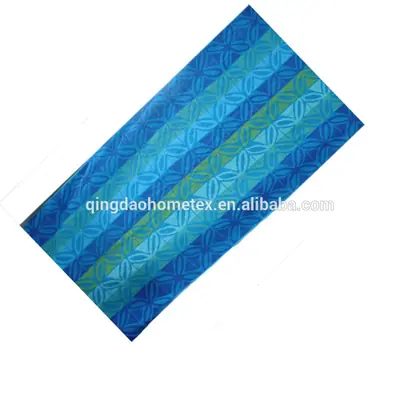 Printed blue fabric or towel with striped circular geometric pattern, laid diagonally on white background with watermark