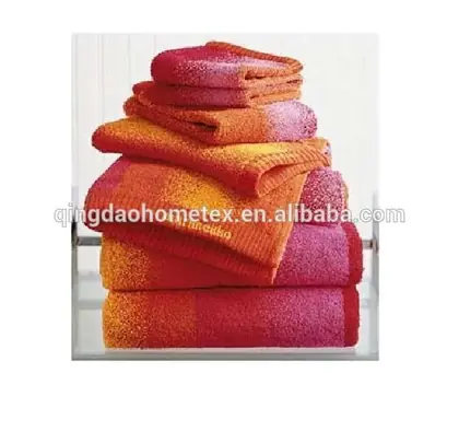 Stack of folded towels with orange, red, and magenta gradient stripes on a white background