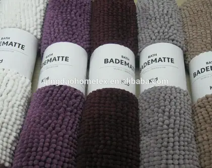 Five chenille bath mats in white, purple, brown, grey, and beige with paper labels.