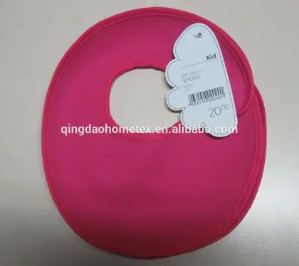 A pink baby bib with a white hangtag on a plain background.