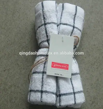 Two white kitchen towels with a black grid pattern tied together with twine and a tag.