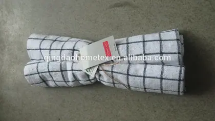 White tea towel with grey windowpane check pattern, rolled and tied with string and paper hang tags