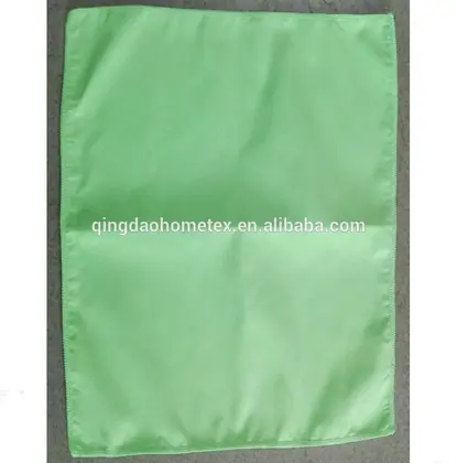 Light green rectangular cloth or napkin lying flat on a gray surface