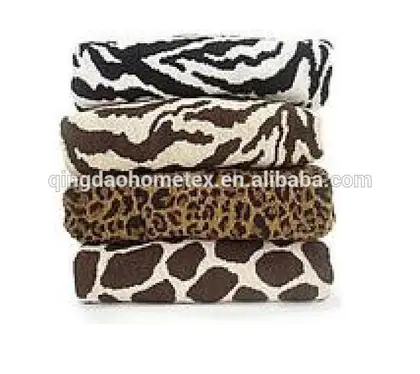 Stack of four folded animal-print towels: zebra, tiger, leopard, and giraffe patterns on white background