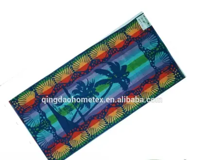Colorful beach towel with palm tree and shell border design, tilted on white background, with BSCI and Oeko-Tex logos below
