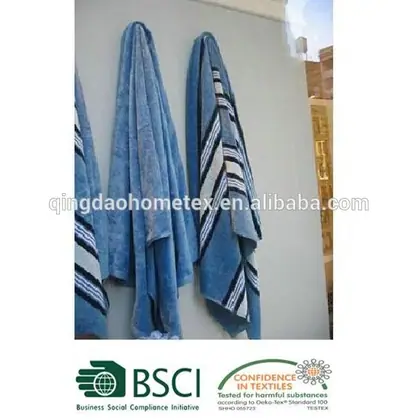 Blue striped beach towels hanging over a balcony rail