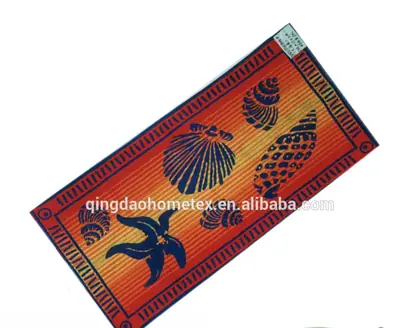 Orange and navy printed beach towel with seashell and starfish designs, shown diagonally on white background