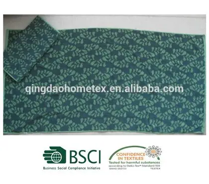 Green leaf-patterned towels on light background, with BSCI and Confidence in Textiles certification logos below