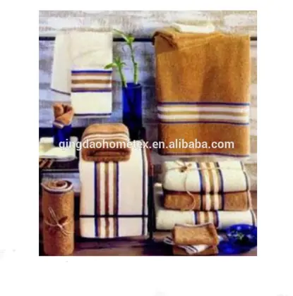 Assorted striped towels in beige, brown, and cream displayed with blue vases