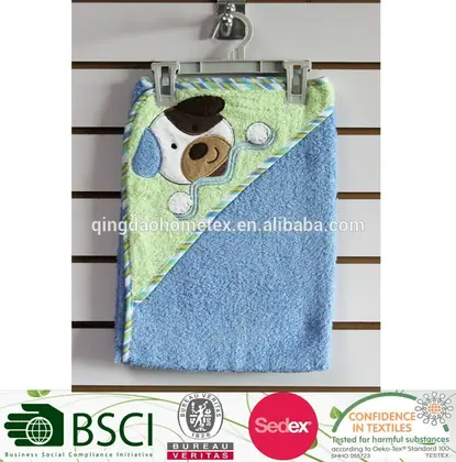 Blue and green baby hooded towel with embroidered dog applique, hanging on a slatwall display