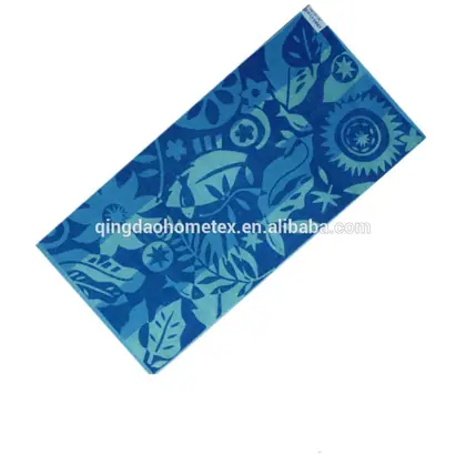 Blue floral printed beach towel shown diagonally on a white background