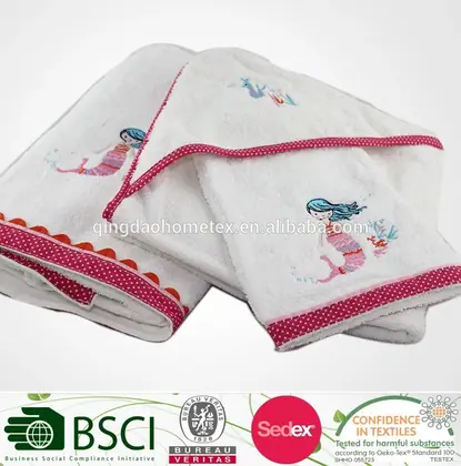 White baby hooded towels with mermaid embroidery and pink polka-dot trim, certification logos overlaid at bottom