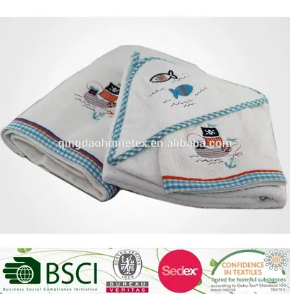 Folded white embroidered baby towels with pirate ship and fish designs and gingham trim