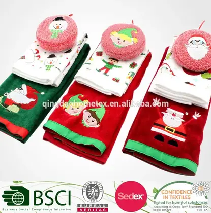 Christmas-themed embroidered towels and round face towels in red and green, folded in rows on a white background.