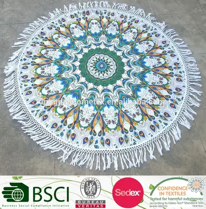 Round mandala-patterned tapestry with peacock design, fringe edges, displayed on gray pavement