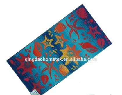 Colorful beach towel with starfish and shell prints on a blue background, shown at an angle