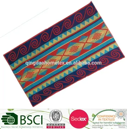 Colorful geometric-patterned woven textile rug with red, blue, and teal designs, tilted on white background