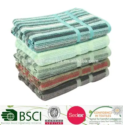 Stack of folded striped towels in teal, green, red, and brown on a white background