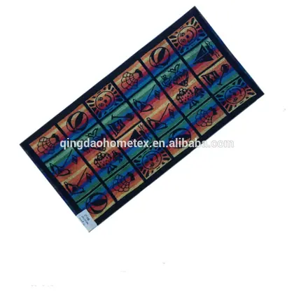 Colorful striped beach towel with beach-themed novelty prints laid diagonally on a white background