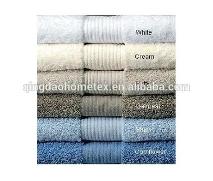Stack of folded towels in six colors labeled White, Cream, Ivory, Oatmeal, Blue, and Cornflower