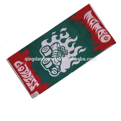 Red and green printed towel with flame and roller skate graphics and white text, shown on white background