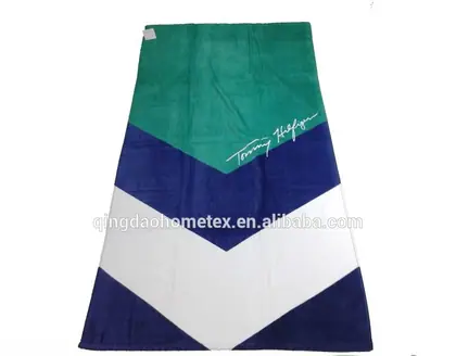 Beach towel with green, navy, and white chevron panels and a script logo, shown flat with BSCI and Oeko-Tex badges below