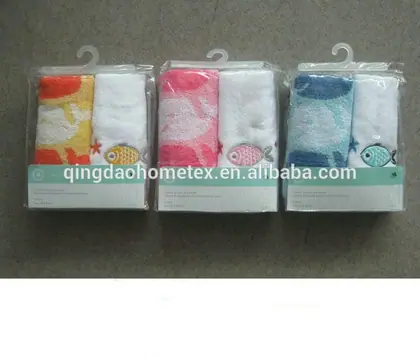 Three packaged sets of printed towels in yellow, pink, and blue with fish designs on retail hangers