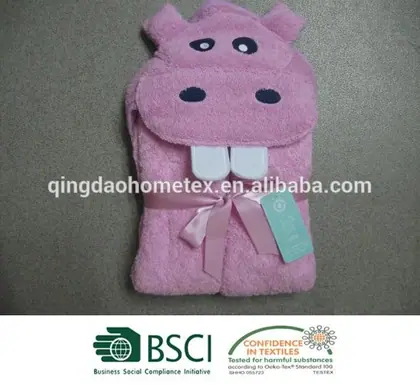 Folded pink hippo-shaped hooded baby towel with ribbon bow and tag, with BSCI and Confidence in Textiles logos below