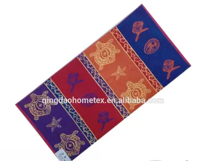 Colorful beach towel with turtle and starfish patterns in purple, red, orange, and blue