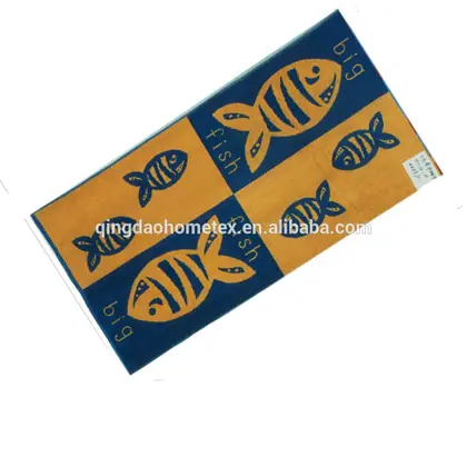 Beach towel with orange and navy fish-print panels, rotated diagonally on white background