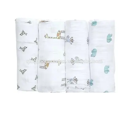 Four rolled white baby muslin swaddle blankets with bird, giraffe, monkey, and elephant prints